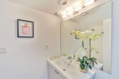 a white bathroom with a sink and a mirror at Center of Joy in Sunny Isles Beach