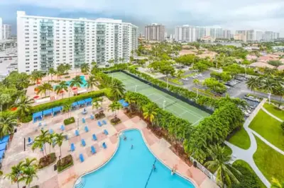 an aerial view of a resort with a tennis court at Center of Joy in Sunny Isles Beach