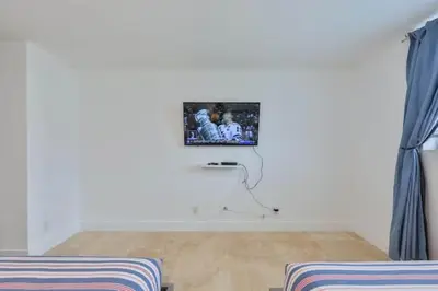 a living room with a tv on the wall at 2bed free parking ocean view STR - 02584 in Sunny Isles Beach