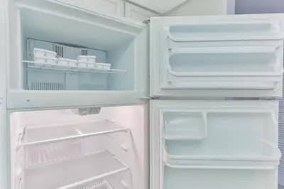 an open refrigerator with its door open and its at The Elevated Above STR-02687 in Sunny Isles Beach