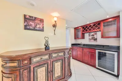 a kitchen with wooden cabinets and a counter top at Ocean view Penthouse - Royal stay in Sunny Isles Beach