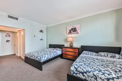 a bedroom with two beds and a dresser in it at Ocean view Penthouse - Royal stay in Sunny Isles Beach