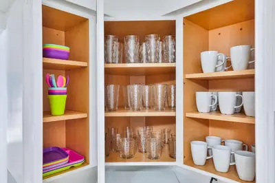 a cupboard filled with lots of glasses and dishes at Quiet family vacation minutes from Airport in Fort Lauderdale