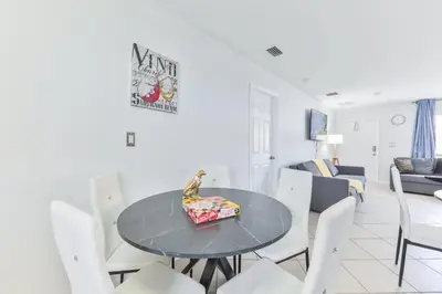 a dining room and living room with a table and chairs at Fantastic Family Nest for Joy STR-2310#1 in Fort Lauderdale