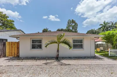 a house with a palm tree in front of it at Fantastic Family Nest for Joy STR-2310#1 in Fort Lauderdale