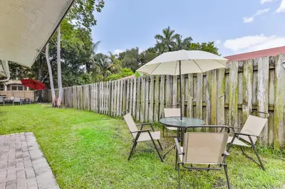 a table and chairs with an umbrella in the yard at Fort Lauderdale Family Bestseller in Fort Lauderdale