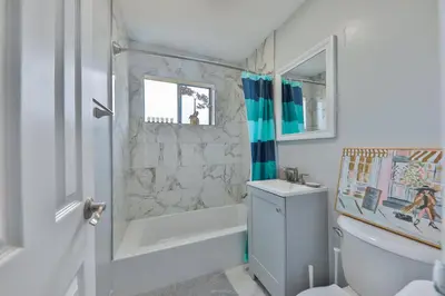 a bathroom with a shower and a toilet and a sink at Hard Rock Family House in Fort Lauderdale