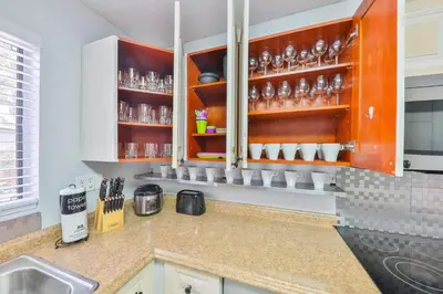 a kitchen with orange cabinets and a counter top at Hard Rock Family House in Fort Lauderdale