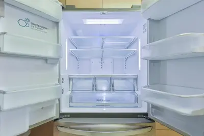 an empty refrigerator with its door open with its door open at Hard Rock Family House in Fort Lauderdale
