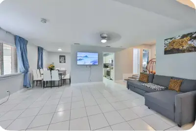 a living room with a couch and a dining room at Hard Rock Family House in Fort Lauderdale