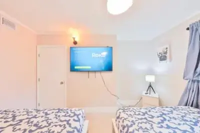 a bedroom with a bed and a tv on the wall at Cruise Family house STR-1761 in Fort Lauderdale