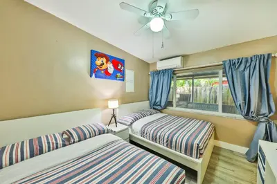 a bedroom with two beds and a window at Garden botanical Villa with jacuzzi in Hollywood