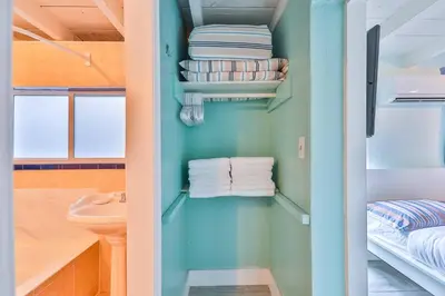 a bathroom with blue walls and a sink and towels at Garden botanical Villa with jacuzzi in Hollywood