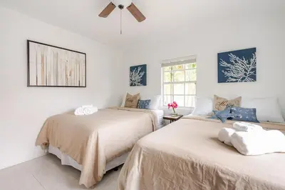 two beds in a room with white walls at Sunset Villa- 3 Bedroom 2 Bathroom -6 Beds in Miami