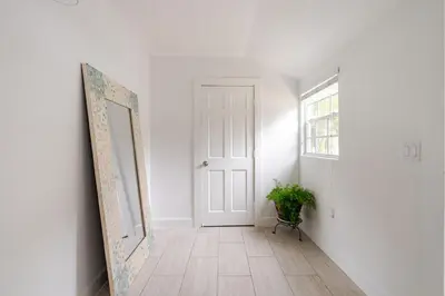 a hallway with a door and a mirror and a plant at Sunset Villa- 3 Bedroom 2 Bathroom -6 Beds in Miami