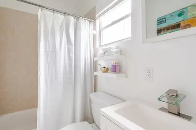 a white bathroom with a toilet and a sink at Sunset Villa- 3 Bedroom 2 Bathroom -6 Beds in Miami