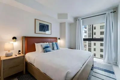 a bedroom with a large bed and a large window at Urban Oasis Luxury Suite- Sky High Amenities in Miami