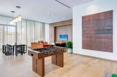 a living room with a kitchen with a stove at Urban Oasis Luxury Suite- Sky High Amenities in Miami
