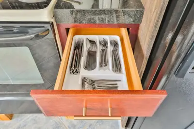 a wooden drawer with forks and plates in it at Hollywood Family Vibes in Hollywood