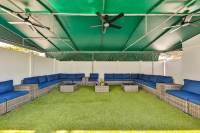a waiting room with blue couches and a green ceiling at Hollywood Family Vibes in Hollywood