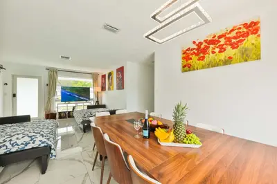 a living room with a table with a bowl of fruit on it at Classy Family Stylish Swimming Joy in Hollywood