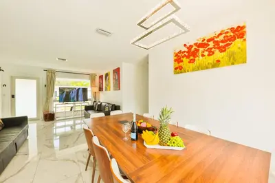 a living room with a wooden table with fruit on it at Classy Family Stylish Swimming Joy in Hollywood