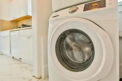 a white washing machine in a kitchen with white cabinets at Classy Family Stylish Swimming Joy in Hollywood