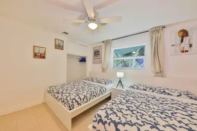 a bedroom with two beds and a ceiling fan at Friday Family Feels Only in Hollywood