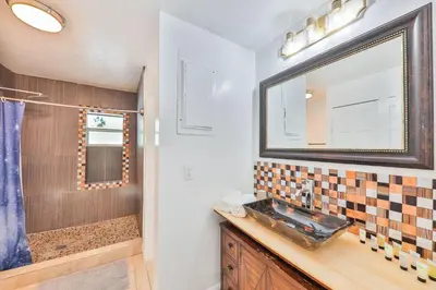 a bathroom with a sink and a mirror at Release your nature in Hallandale Beach