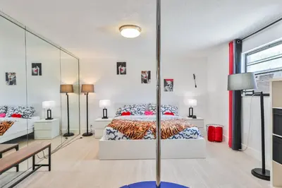 a bedroom with a bed and a large mirror at Release your nature in Hallandale Beach