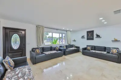 a large living room with couches and a large window at Marble Villa Prime Location in Hollywood