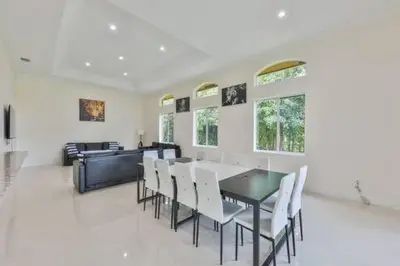 a dining room with a table and white chairs at Luxury Family Davie Rancho STR-6114 in Davie