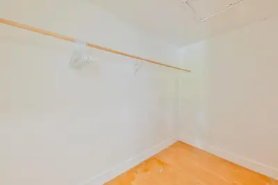 an empty room with white walls and a wooden floor at Haunted corner of Aventura Villa in Miami