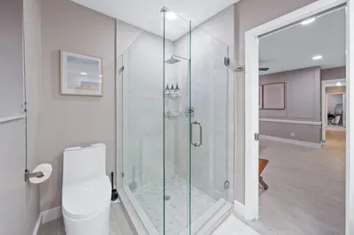 a bathroom with a glass shower with a toilet at SUN VILLA Heated Pool Near Hard Rock & Beach in Hollywood