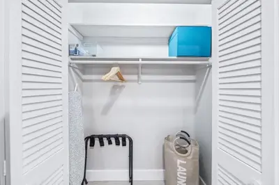 a walk in closet with white walls and wooden closets at SUN VILLA Heated Pool Near Hard Rock & Beach in Hollywood