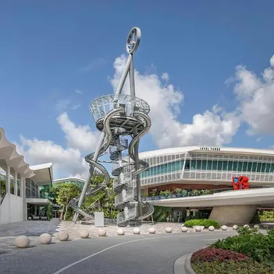a metal sculpture of a shopping cart in front of a building at SUN VILLA Heated Pool Near Hard Rock & Beach in Hollywood