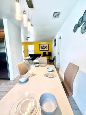a dining room with a table with bowls on it at Better Experience Property in Miramar