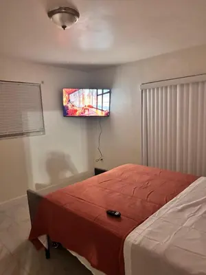 a bedroom with a bed and a tv on the wall at Better Experience Property in Miramar