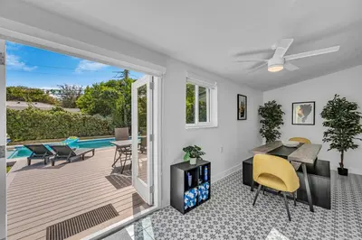 a living room with a patio and a pool at The Design District Pool House in Miami