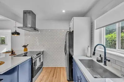 a kitchen with a sink and a refrigerator at The Design District Pool House in Miami