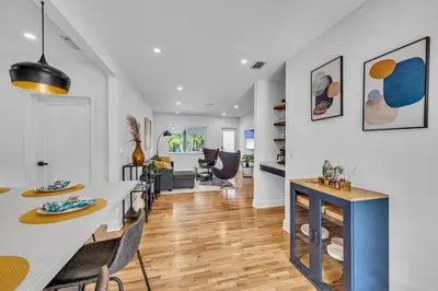 a kitchen and living room with a table and chairs at The Design District Pool House in Miami