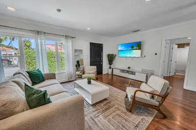 a living room with a couch and a table at Blue Heaven Poolside Retreat Brickell Sleeps 13 in Miami