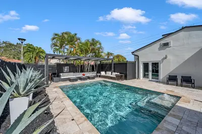 a swimming pool in the backyard of a house at Blue Heaven Poolside Retreat Brickell Sleeps 13 in Miami