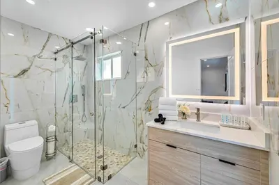 a bathroom with a shower and a toilet and a sink at Casa Sol in Richmond Heights