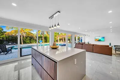 a kitchen and living room with a view of a pool at Casa Sol in Richmond Heights