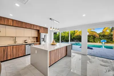 a kitchen with a large island and a pool at Casa Sol in Richmond Heights