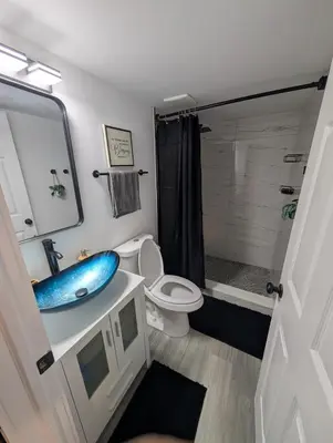 a bathroom with a blue sink and a toilet at PrimeStay Modern Studio in Prime Location in Hollywood
