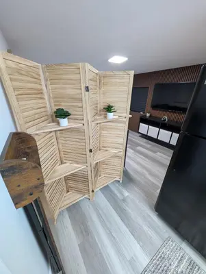a room with wooden cubicles with plants on them at PrimeStay Modern Studio in Prime Location in Hollywood