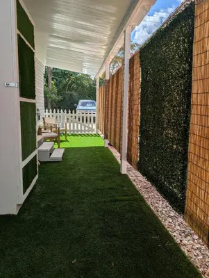 an enclosed patio with a fence and a bench at PrimeStay Modern Studio in Prime Location in Hollywood