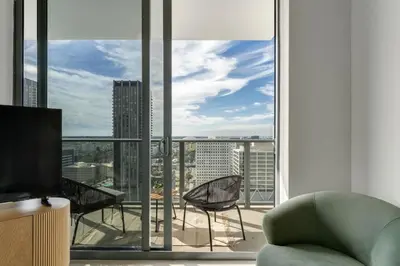 a living room with a view of a city at Crosby Miami WTC 2BR 2BA High Floor Corner #3101 in Miami